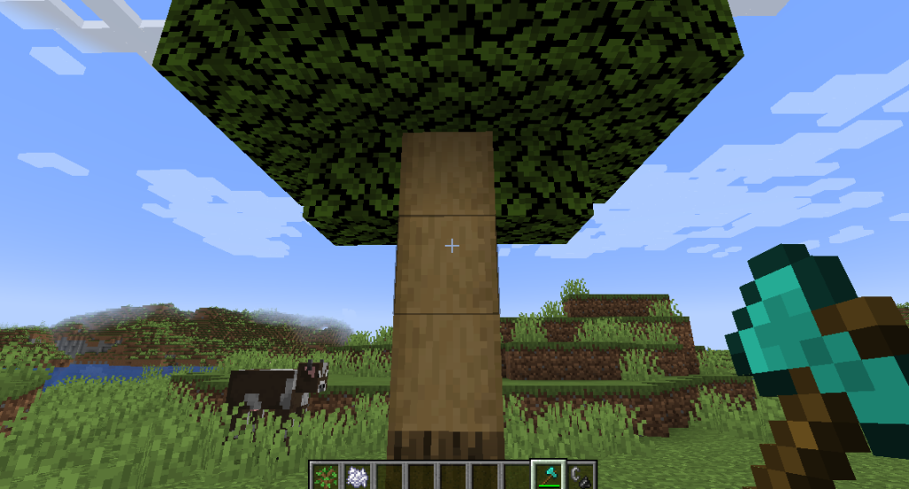 Logs can be stripped directly on a tree by holding an axe and using the interact button specific to your version of Minecraft.
