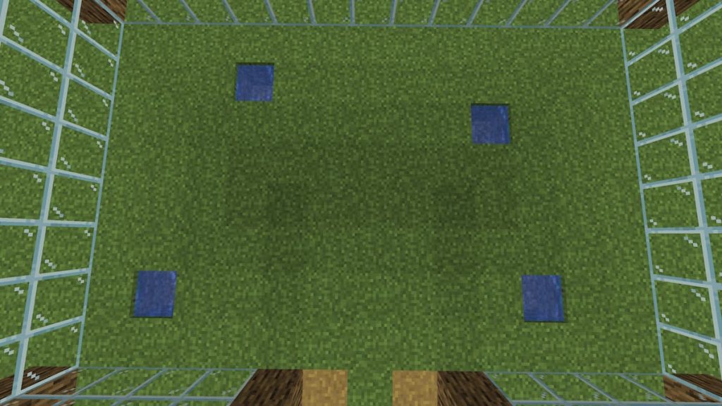 Placing water holes for crops in the Minecraft greenhouse.